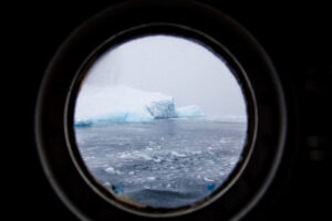 Iceberg through a porthole, Antarctica