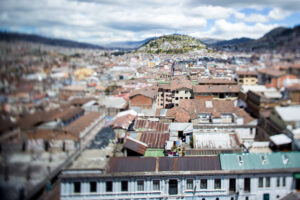 Cityscape of Quito Ecuador taken with a tilt-shift lens from la Catedral, looking toward el Panecillo. Shows housing, office buildings and architectural details
